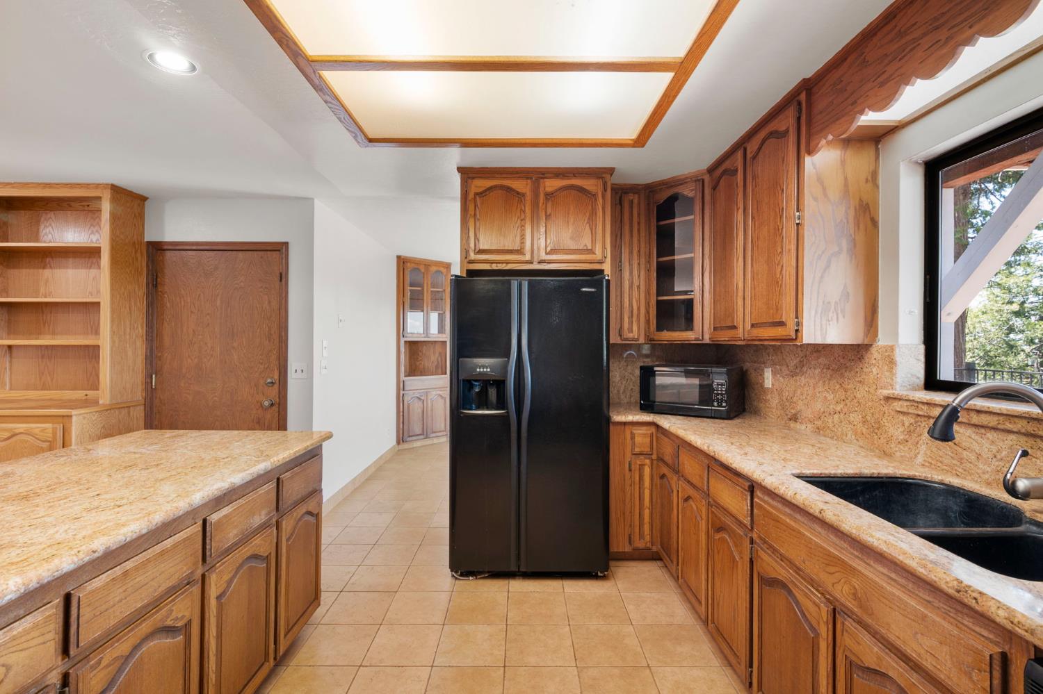 24835 Shake Ridge Road Volcano, CA 95689 - Photo 21 of 79 a kitchen with stainless steel appliances granite countertop a refrigerator and a sink