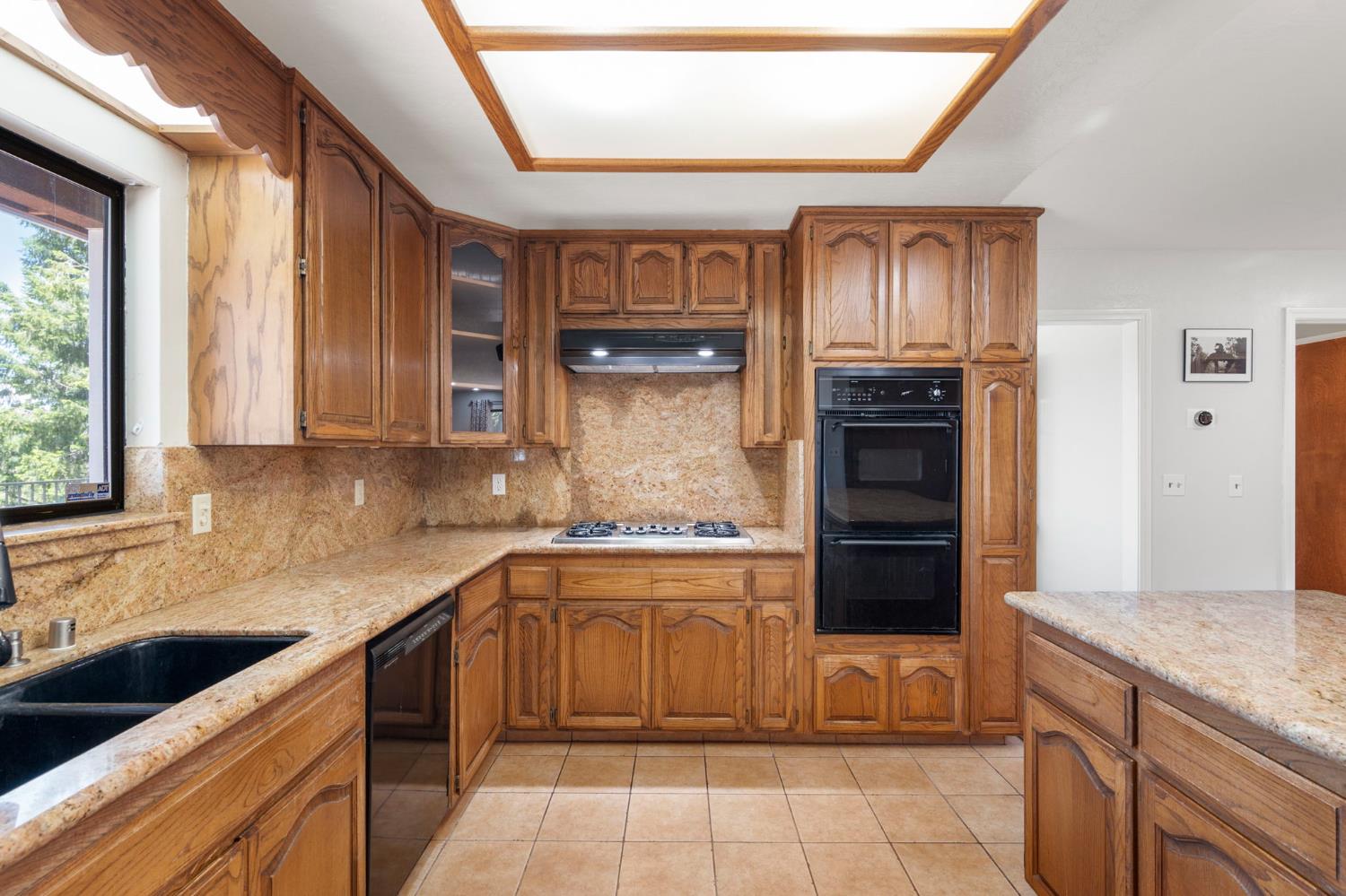 24835 Shake Ridge Road Volcano, CA 95689 - Photo 22 of 79 a kitchen with stainless steel appliances granite countertop a stove and a sink