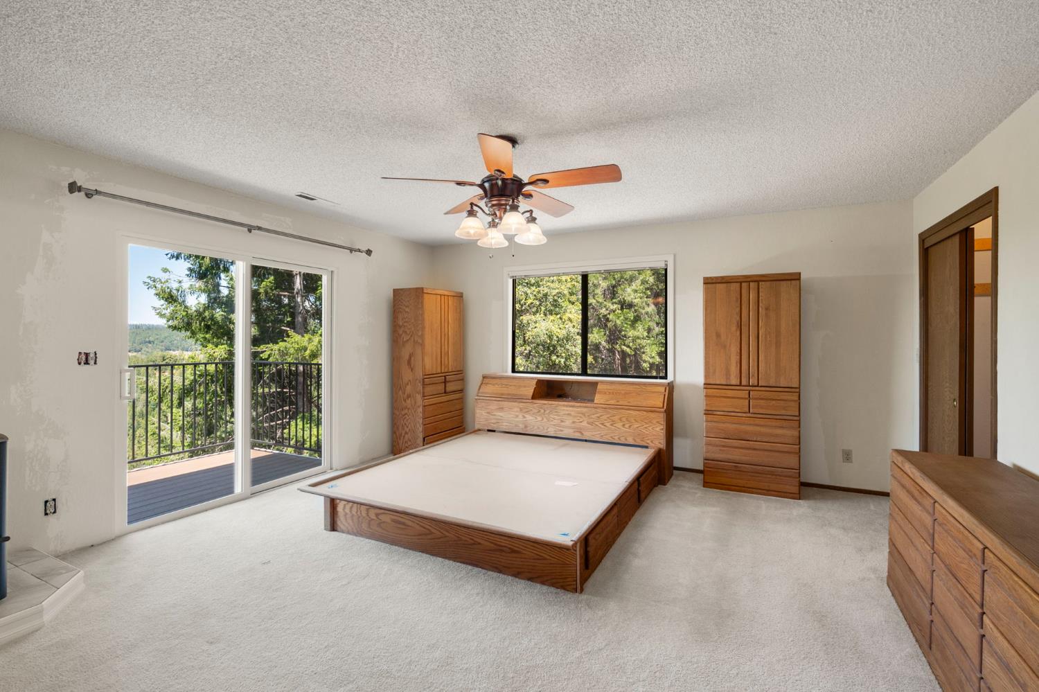 24835 Shake Ridge Road Volcano, CA 95689 - Photo 31 of 79 a spacious bedroom with a large bed and a large window