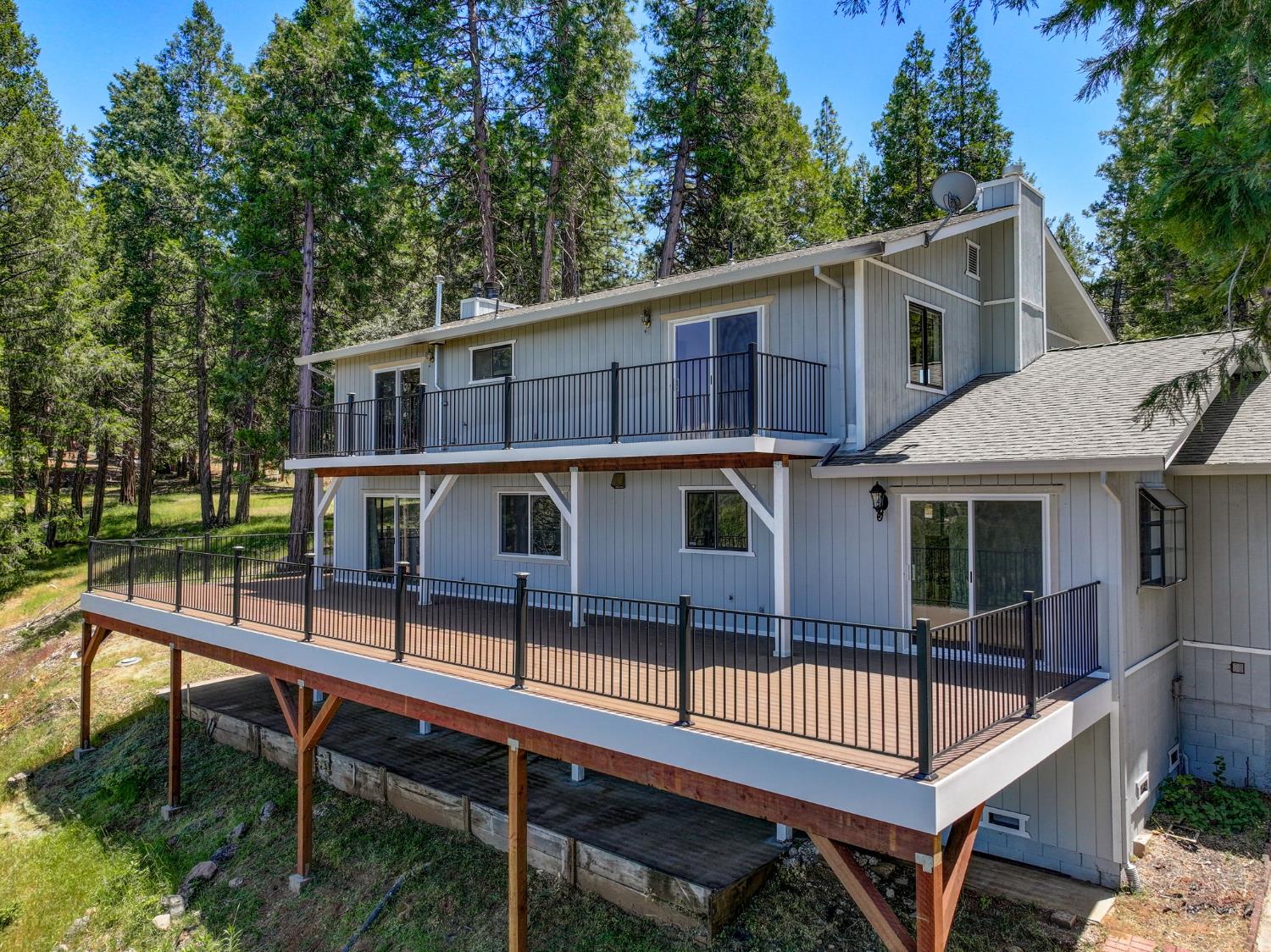 24835 Shake Ridge Road Volcano, CA 95689 - Photo 50 of 79 a view of a roof deck with table and chairs a barbeque with wooden floor and fence