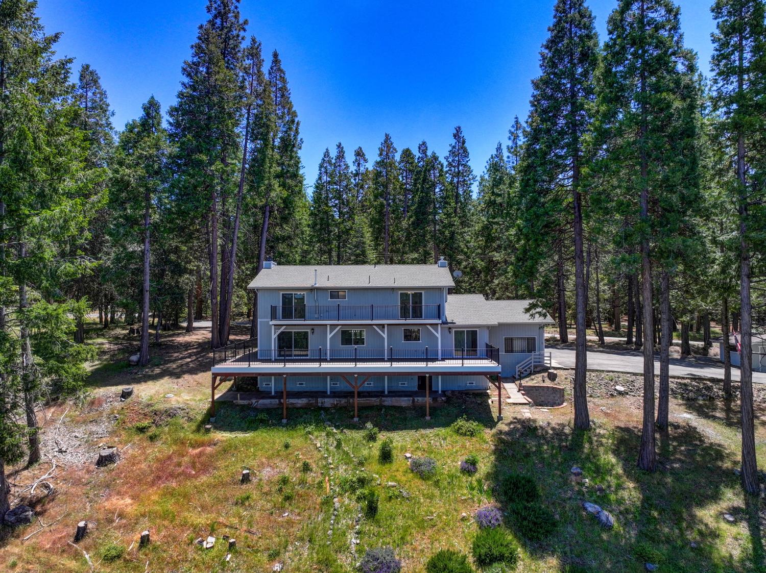 24835 Shake Ridge Road Volcano, CA 95689 - Photo 54 of 79 a view of a house with swimming pool next to a yard