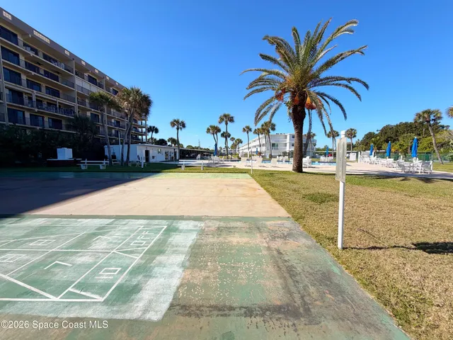 a view of swimming pool with outdoor seating and plants