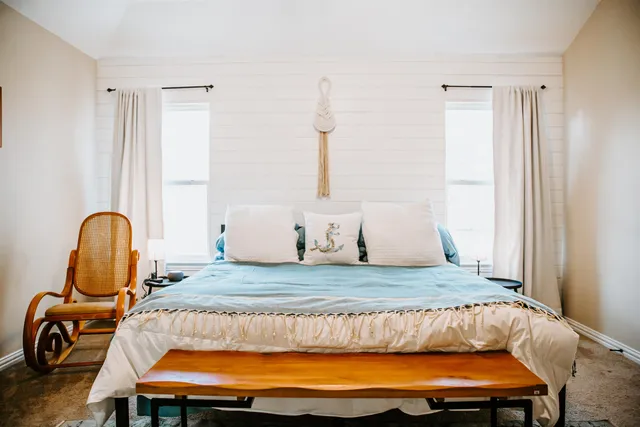 a bedroom with a bed and window