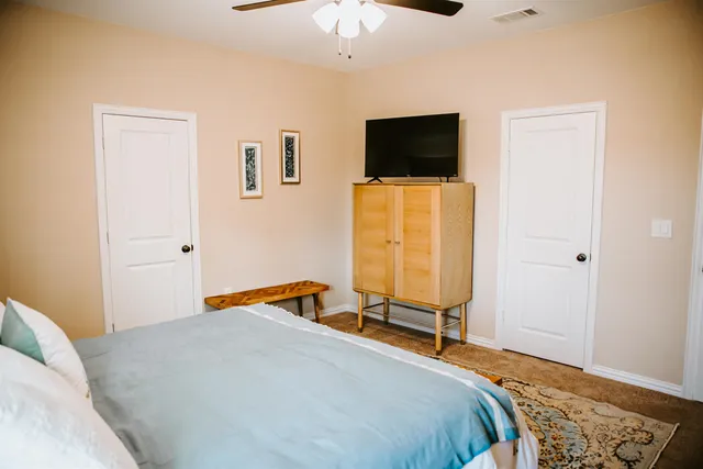 a bedroom with a bed and a flat screen tv