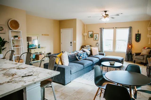 a living room with furniture and wooden floor