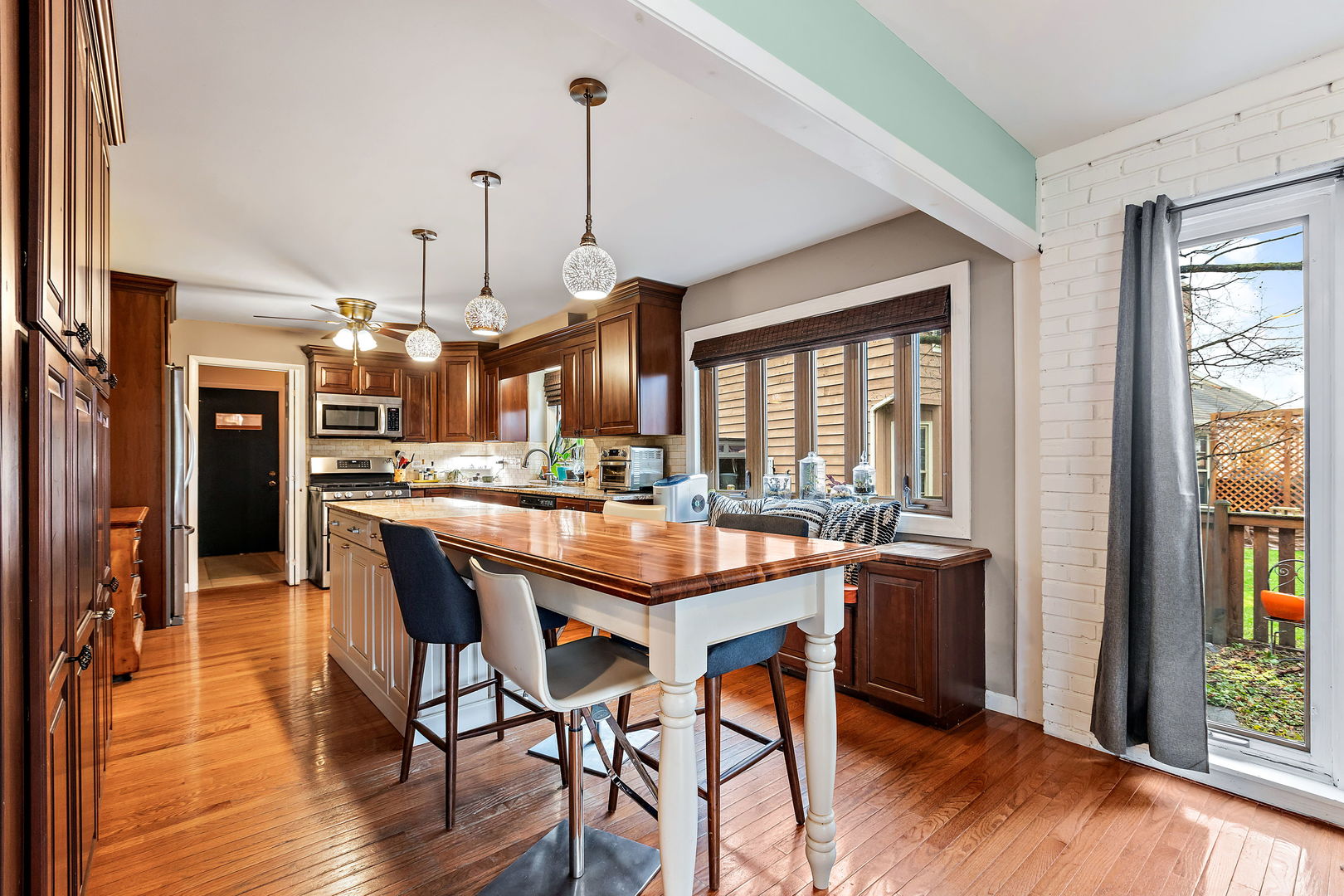 2660 Sun Valley Road Lisle, IL 60532 - Photo 5 of 27 a kitchen with stainless steel appliances granite countertop a table chairs refrigerator and wooden floor