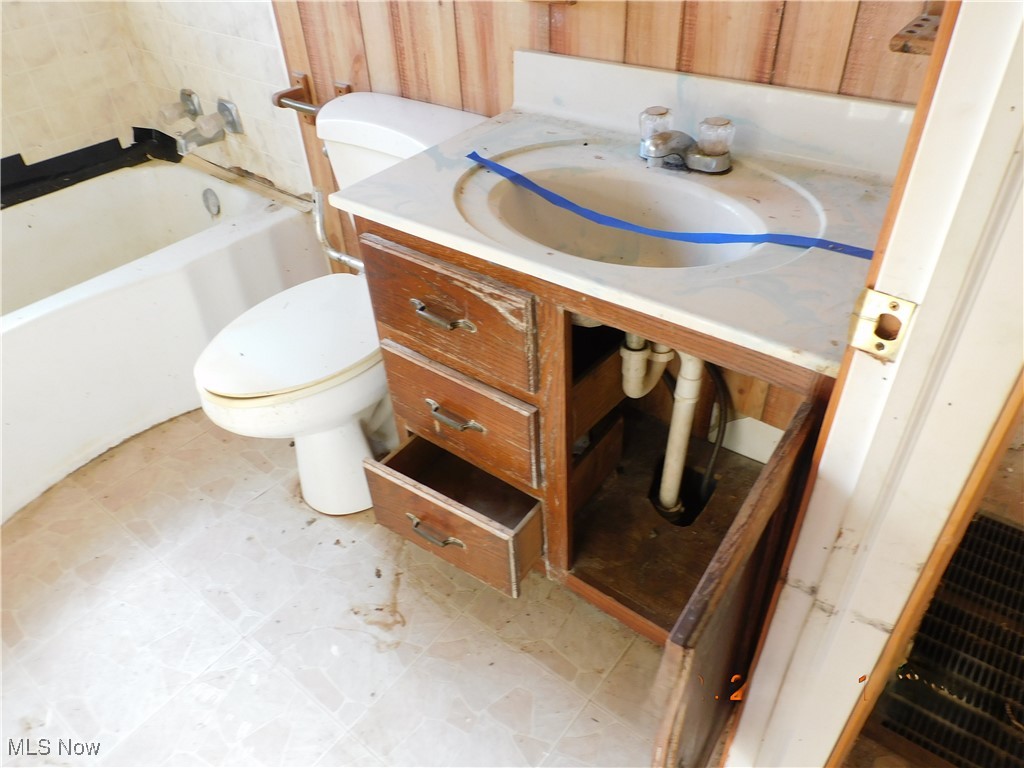 352 South Ridge Road East Conneaut, OH 44030 - Photo 10 of 21 Full bathroom featuring vanity, light floors, and a bath