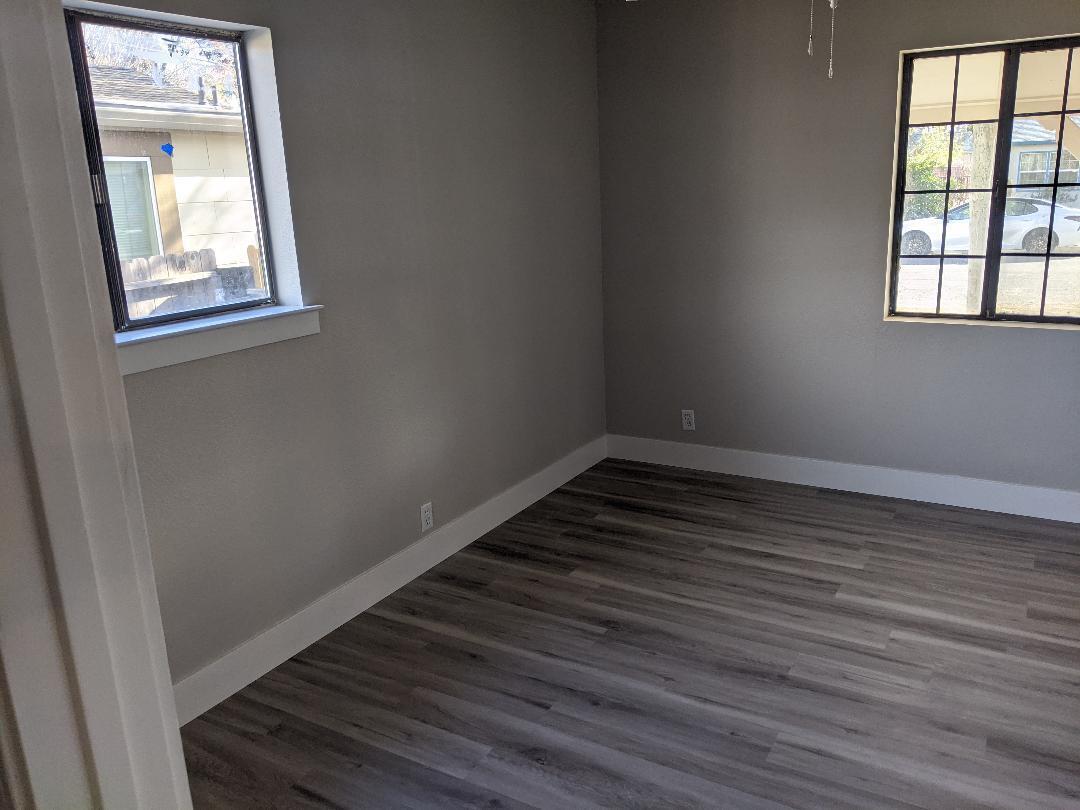 1012 State Street Redding, CA 96001 - Photo 16 of 23 an empty room with wooden floor and windows