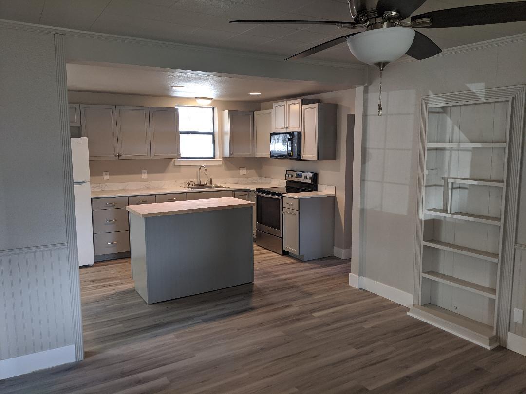 1012 State Street Redding, CA 96001 - Photo 4 of 23 a kitchen with stainless steel appliances granite countertop a sink a stove and refrigerator