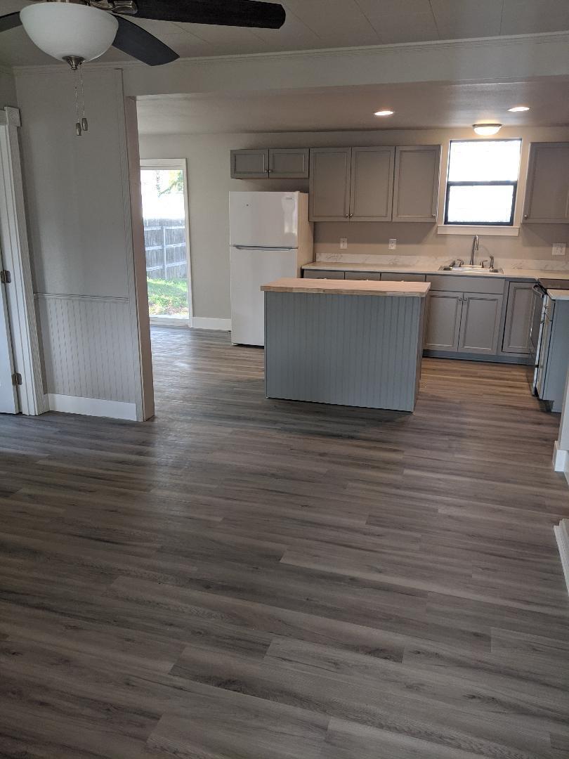1012 State Street Redding, CA 96001 - Photo 5 of 23 a room with kitchen island stainless steel appliances wooden floor and window
