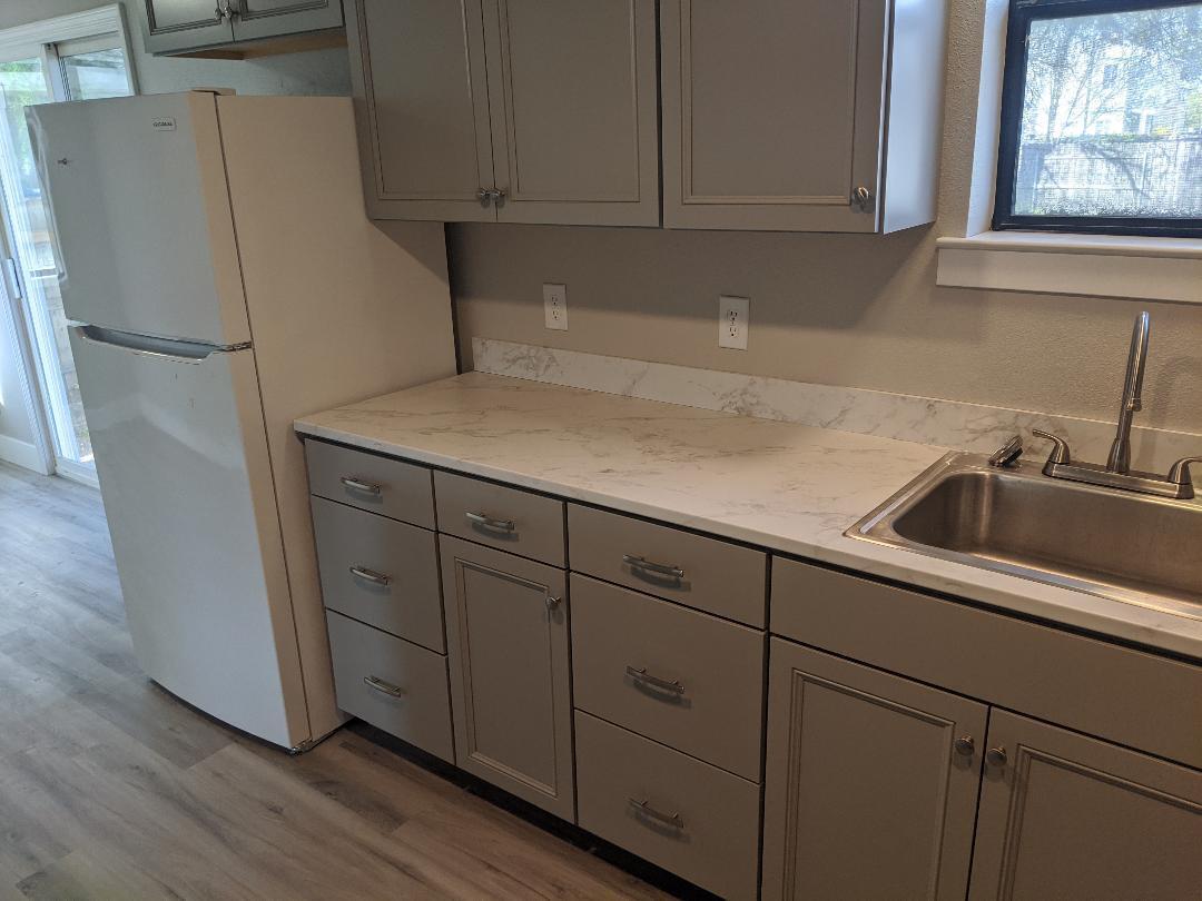 1012 State Street Redding, CA 96001 - Photo 8 of 23 a kitchen with cabinets and a refrigerator