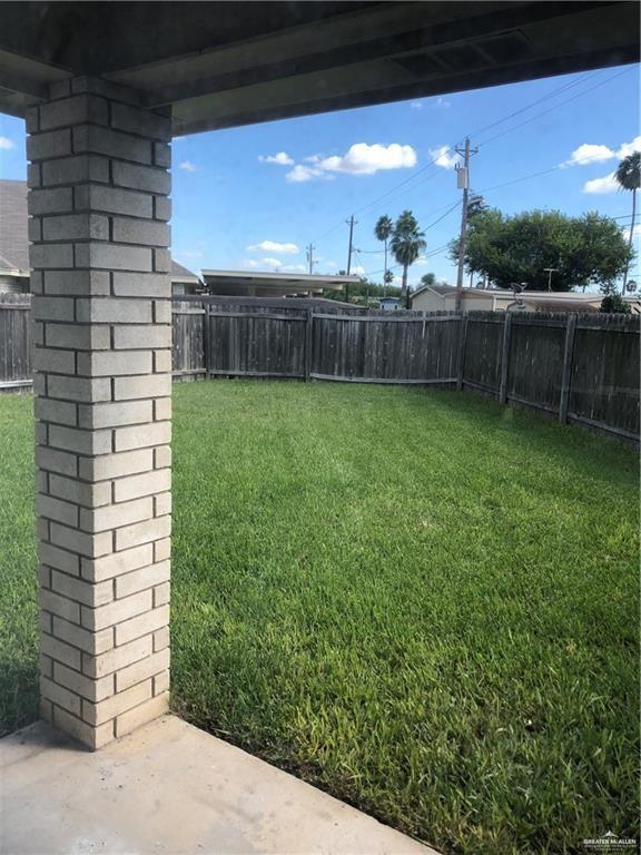 1900 Summer Breeze Street Mission, TX 78572 - Photo 2 of 9 Fenced backyard with a patio area