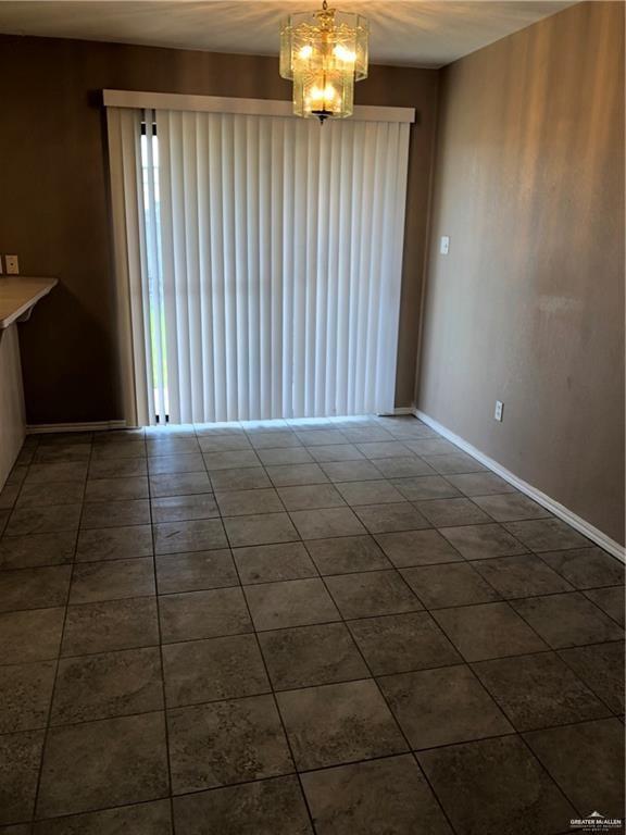 1900 Summer Breeze Street Mission, TX 78572 - Photo 5 of 9 Unfurnished dining area with a chandelier and tile patterned floors