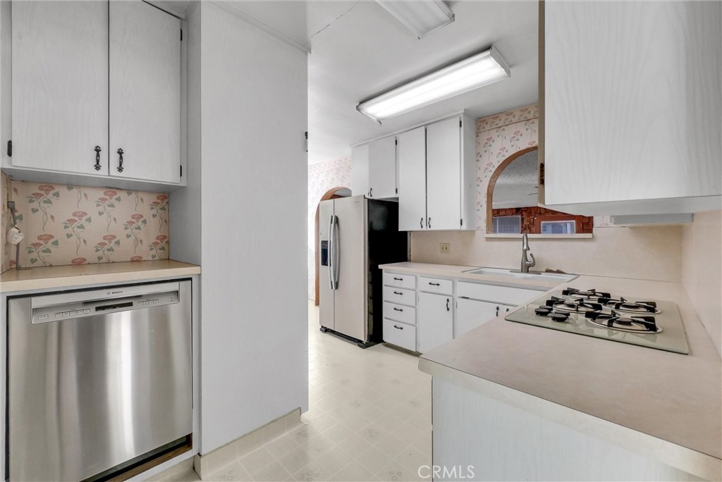 4741 Hazelbrook Avenue Long Beach, CA 90808 - Photo 8 of 22 a kitchen with stainless steel appliances kitchen island granite countertop a refrigerator sink and stove