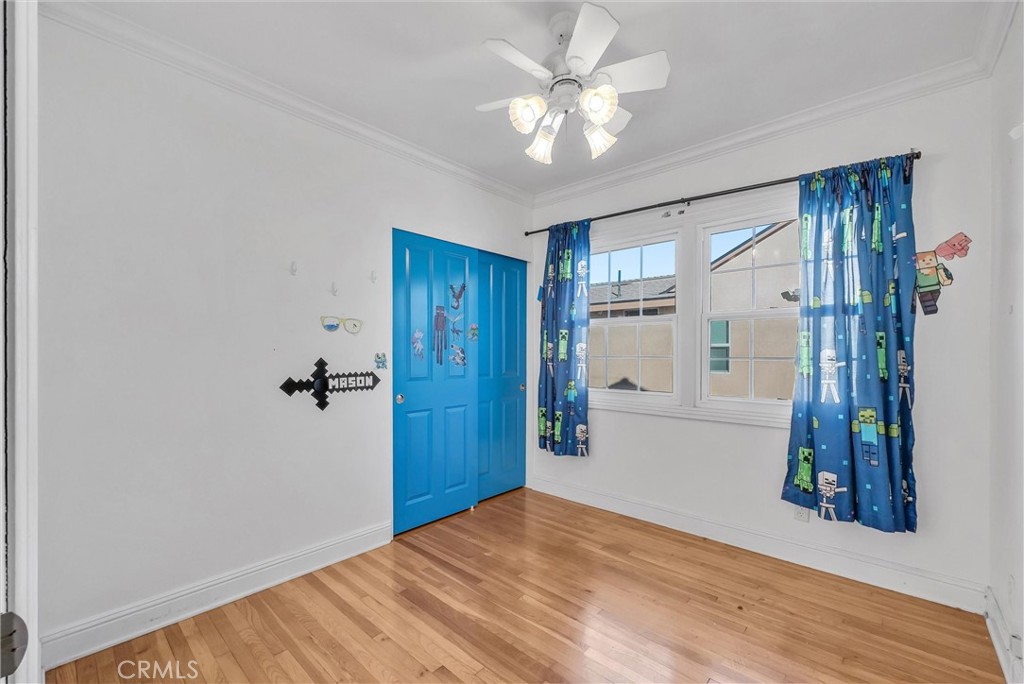4741 Hazelbrook Avenue Long Beach, CA 90808 - Photo 9 of 22 a view of a livingroom with wooden floor and a ceiling fan