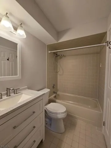 a bathroom with a granite countertop toilet a sink and a shower
