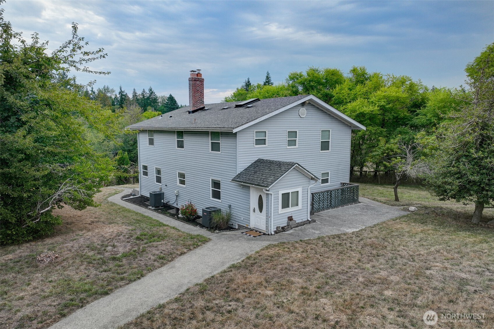 31612 8th Avenue South Roy, WA 98580 - Photo 2 of 40 a view of a house with a yard and large trees
