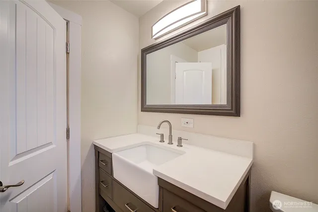 a bathroom with a sink vanity and a mirror