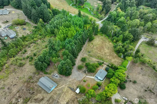 an aerial view of a house with a yard