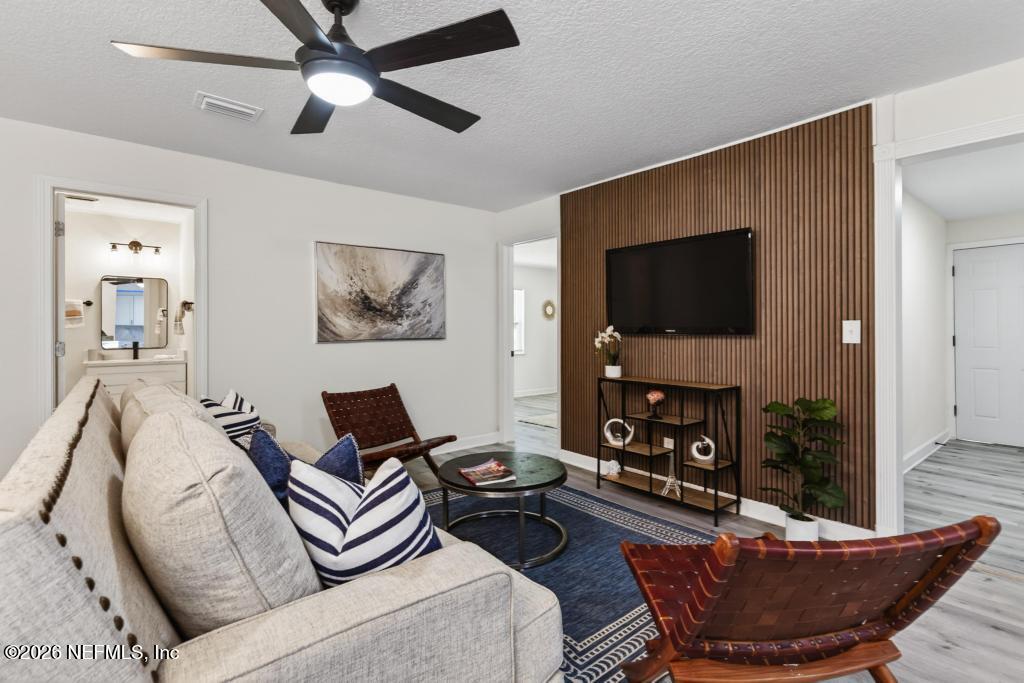 433 Lena Street St. Augustine, FL 32084 - Photo 14 of 42 a living room with furniture and a flat screen tv
