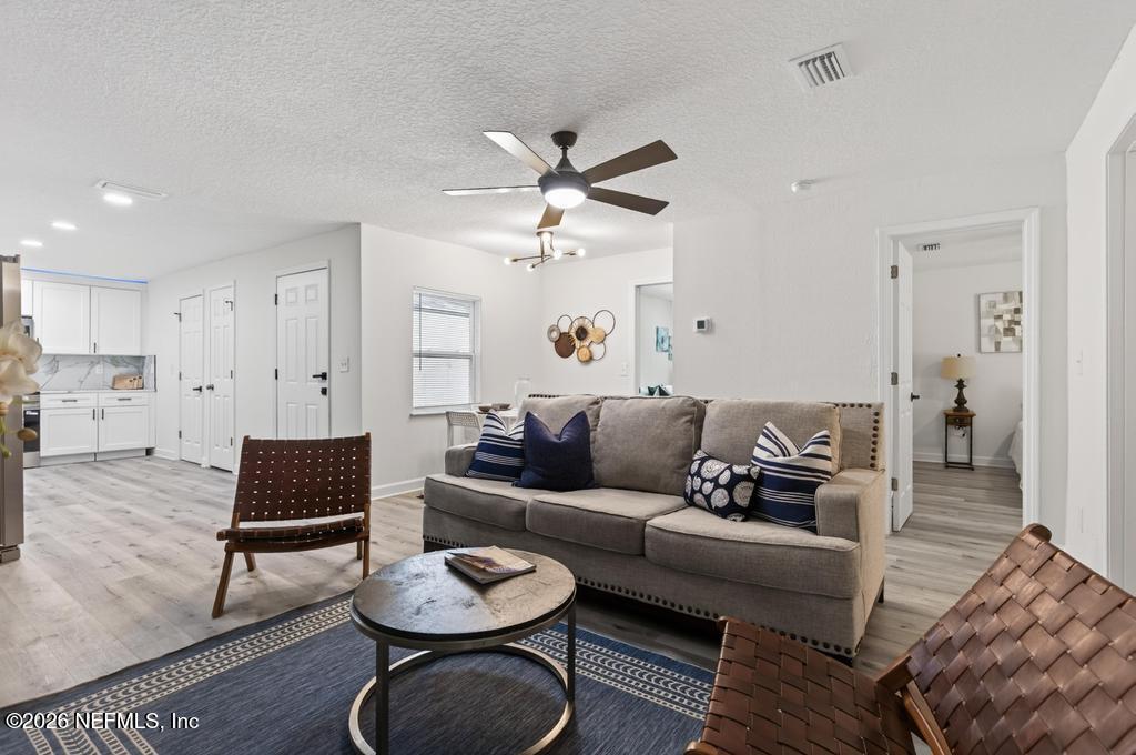 433 Lena Street St. Augustine, FL 32084 - Photo 16 of 42 a living room with furniture and a wooden floor