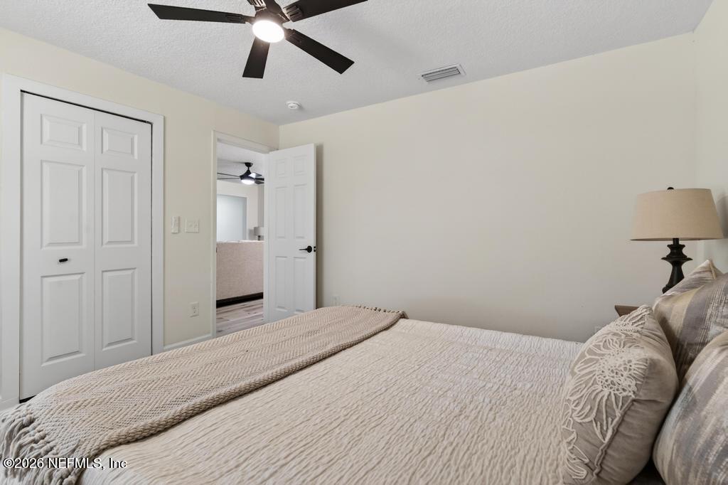 433 Lena Street St. Augustine, FL 32084 - Photo 18 of 42 a bedroom with a bed and a chandelier