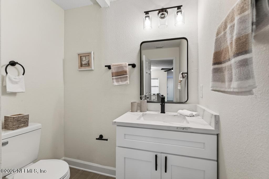 433 Lena Street St. Augustine, FL 32084 - Photo 20 of 42 a bathroom with a toilet sink and mirror