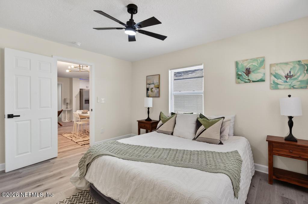 433 Lena Street St. Augustine, FL 32084 - Photo 22 of 42 a bedroom with a large bed and a chandelier