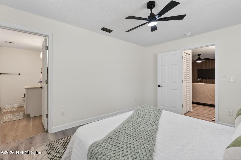 433 Lena Street St. Augustine, FL 32084 - Photo 23 of 42 a bedroom with a bed and a walk in closet