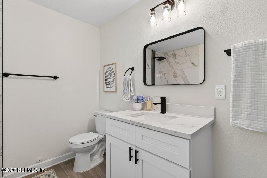 433 Lena Street St. Augustine, FL 32084 - Photo 26 of 42 a bathroom with a toilet sink vanity and mirror