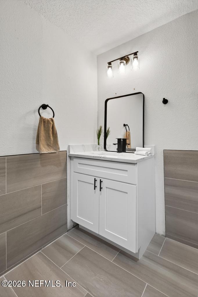 433 Lena Street St. Augustine, FL 32084 - Photo 31 of 42 a bathroom with a sink vanity and mirror