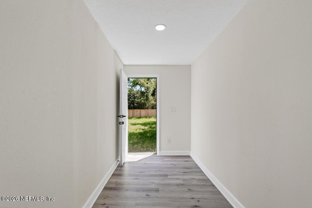 433 Lena Street St. Augustine, FL 32084 - Photo 35 of 42 a view of an empty room with wooden floor and a window
