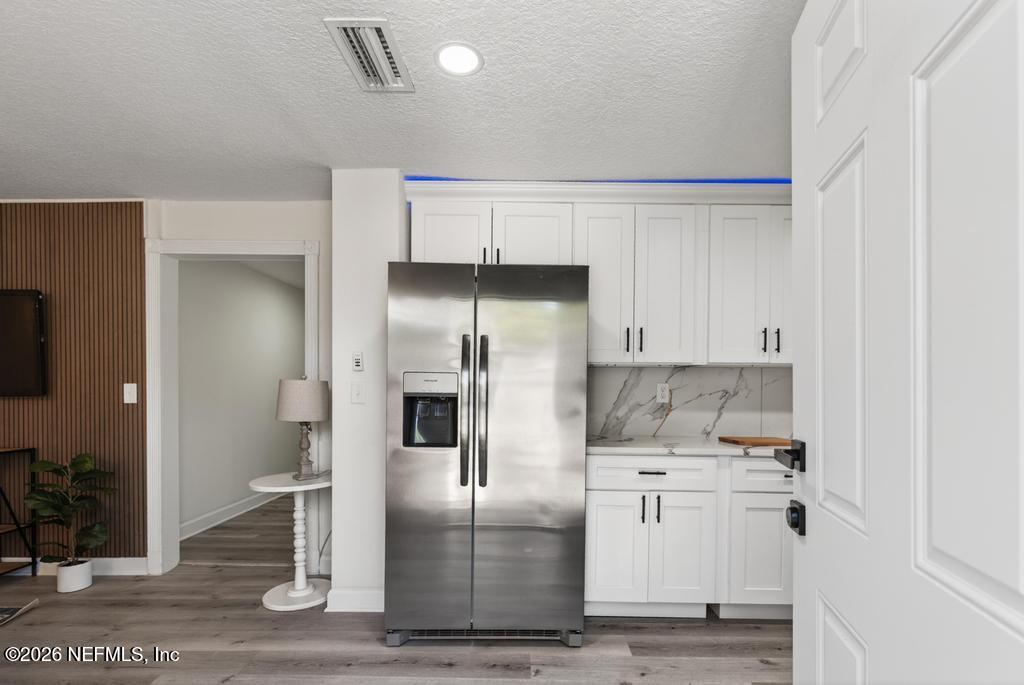 433 Lena Street St. Augustine, FL 32084 - Photo 5 of 42 a kitchen with stainless steel appliances kitchen island a refrigerator sink and cabinets