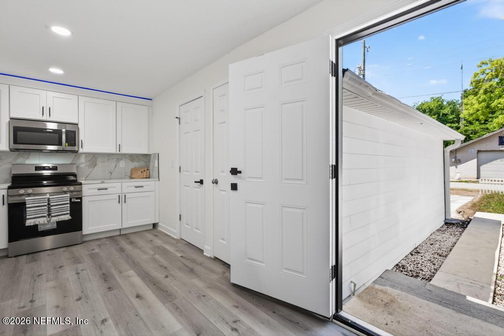 433 Lena Street St. Augustine, FL 32084 - Photo 6 of 42 a kitchen with stainless steel appliances a refrigerator and a stove top oven