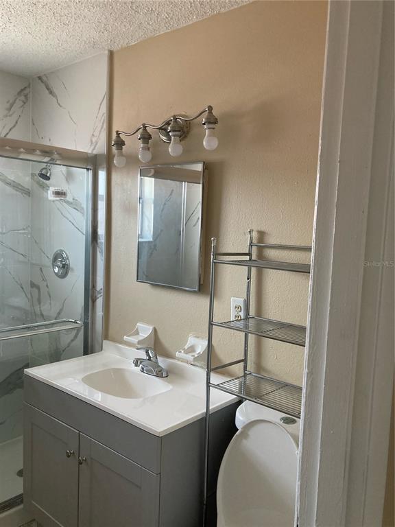 1306 Golconda Road Lakeland, FL 33801 - Photo 13 of 13 a bathroom with a sink toilet and shower