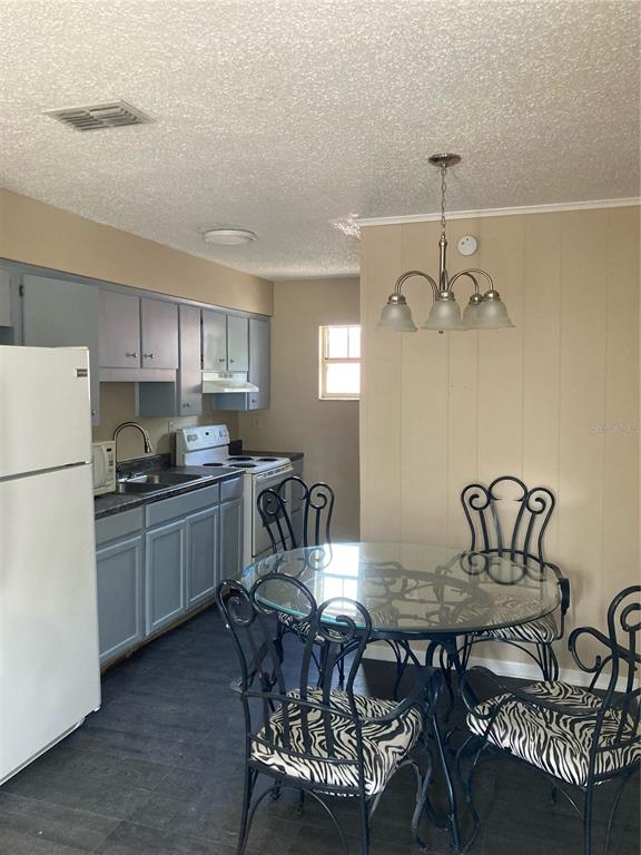1306 Golconda Road Lakeland, FL 33801 - Photo 2 of 13 a kitchen with a dining table chairs and refrigerator