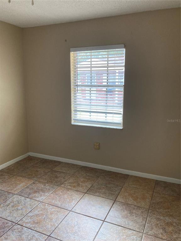 1306 Golconda Road Lakeland, FL 33801 - Photo 8 of 13 a view of an empty room with a window