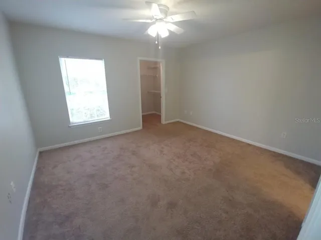 a bathroom with a granite countertop sink a mirror and a shower