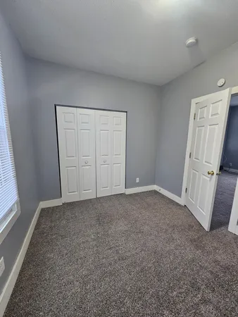 a kitchen with granite countertop a refrigerator and a stove top oven