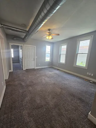 an empty room with a empty space and windows