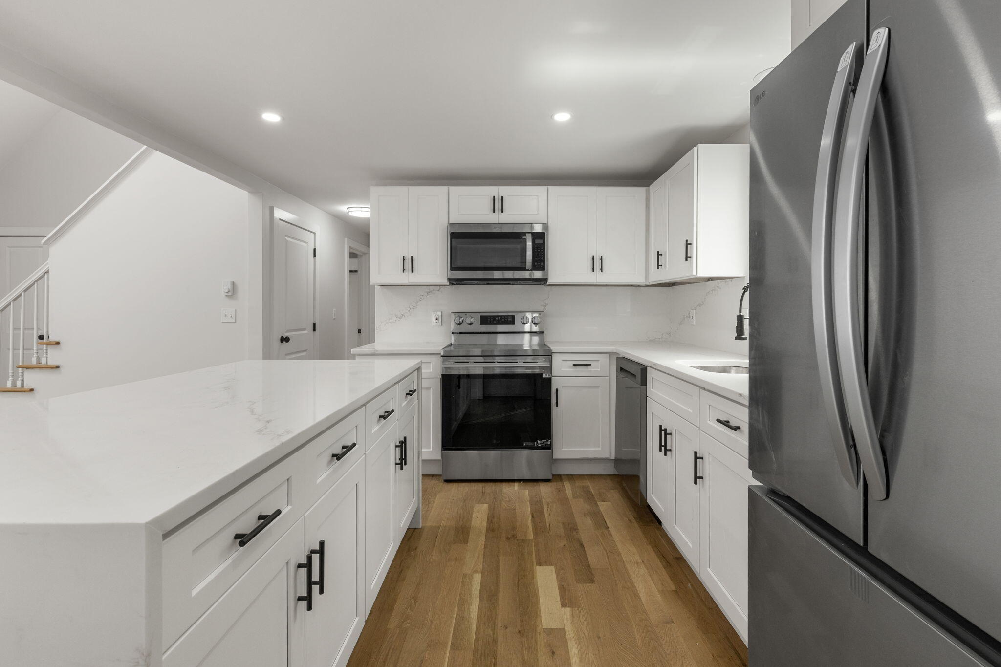81 Sam Turner Road East Falmouth, MA 02536 - Photo 17 of 37 a kitchen with granite countertop a refrigerator sink and white cabinets