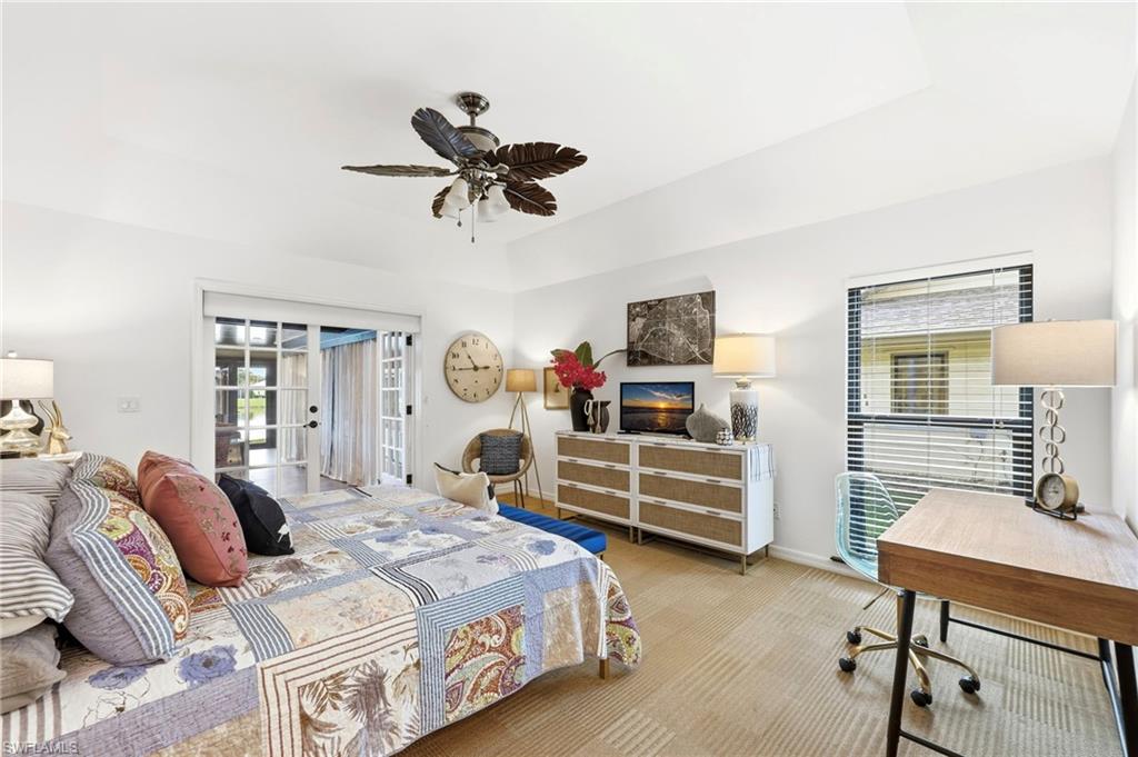 2274 Queens Way Naples, FL 34112 - Photo 13 of 28 a bedroom with a bed and wooden floor