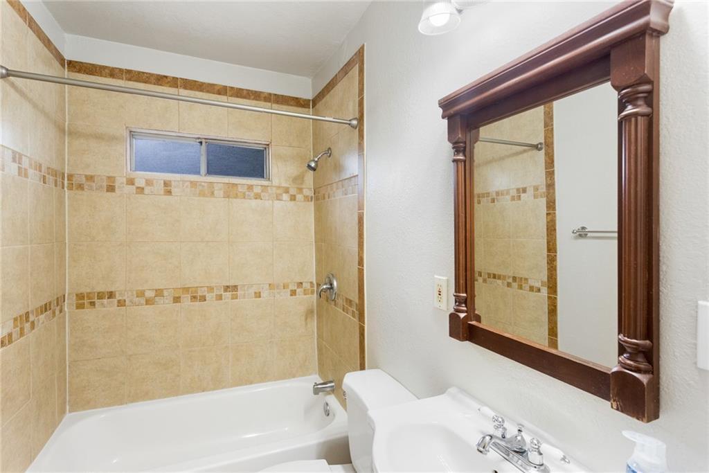 74 Julius Street Austin, TX 78702 - Photo 7 of 11 a bathroom with a bathtub and a shower