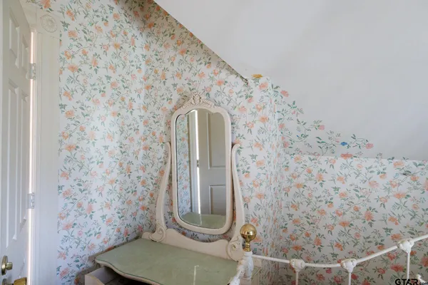 a bathroom with a toilet and a shower curtain