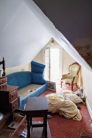 a bedroom with furniture and a wooden floor