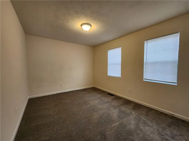 an empty room with a empty space and a window