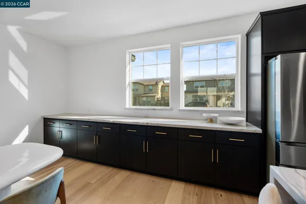 a view of a a dining room with furniture window and wooden floor