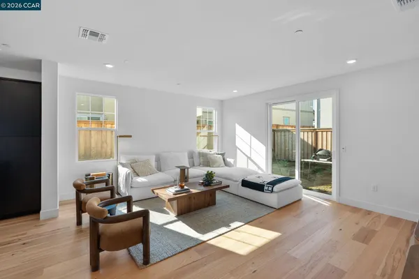 a kitchen with stainless steel appliances kitchen island granite countertop a stove a sink a dining table and chairs