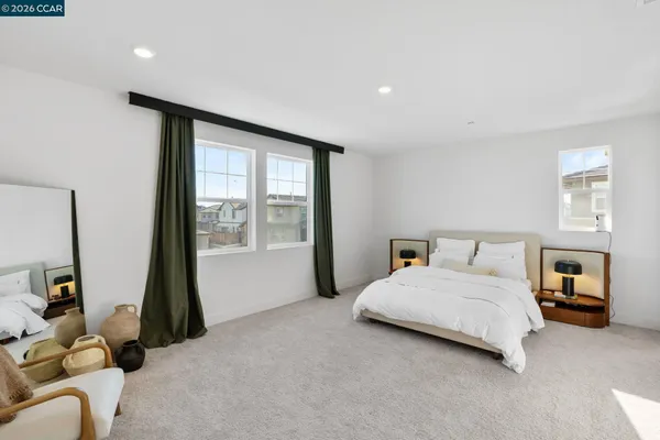 a spacious bedroom with a bed and with furniture