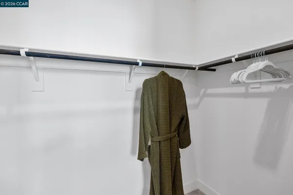 a utility room with cabinets and wooden floor